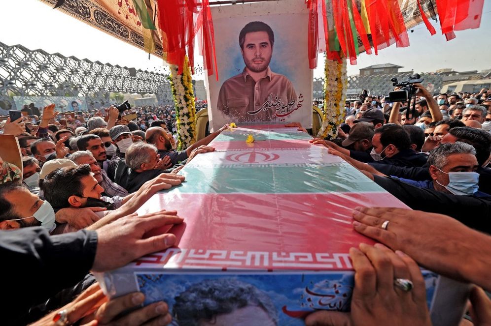 Mourners gather around the coffin of Iran's Revolutionary Guards colonel Sayyad Khodai during a funeral procession at Imam Hussein square in the capital Tehran, on May 24, 2022