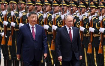 Russian President Vladimir Putin, right, and Chinese President Xi Jinping inspect an honor guard during a welcoming ceremony at the Great Hall of the People in Beijing Wednesday, May 20, 2026. 
