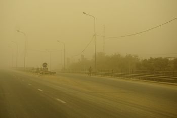 A man walks on a deserted road during a spring sandstorm in Iraq's capital city Baghdad on May 5, 2022.