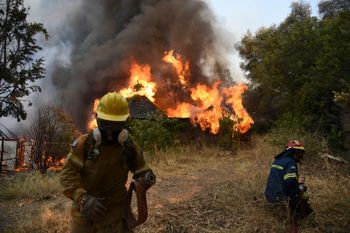 Firefighters operate during a wildfire near Lampiri village, west of Patras, Greece, July 31, 2021.