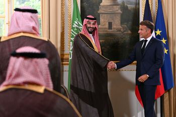 France's President Emmanuel Macron, right, and Saudi Arabia's Crown Prince Mohammed bin Salman shake hands during a trade agreement signature ceremony after their meeting at the Elysee Palace in Paris, Monday Aug. 24, 2026. (Lou Benoist/Pool Photo via AP)
