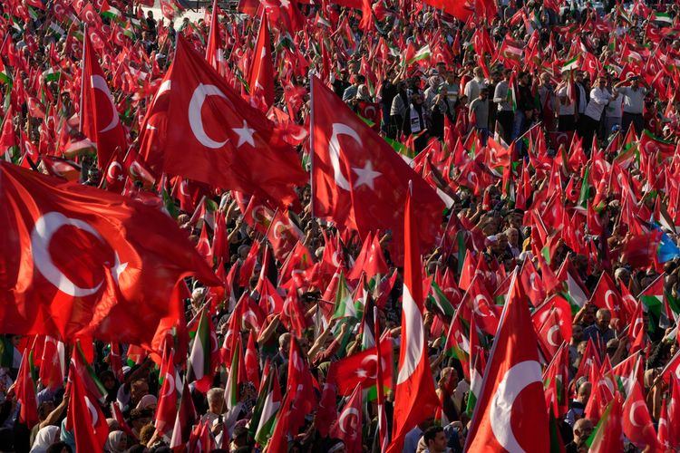 FILE - Protesters wave Turkish and Palestinian flags while attending a rally to show their solidarity with the Palestinians, in Istanbul, Turkey, Saturday, Oct. 28, 2023.