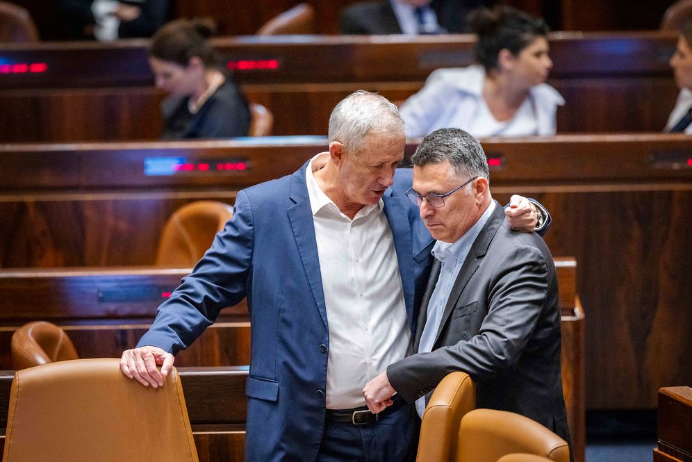 Then-Defense Minister Benny Gantz speaks with then-Justice Minister Gideon Saar in the Knesset