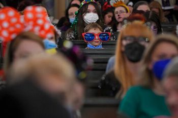 A child wears a pair of oversized glasses as Romania's Jewish community celebrates Purim at the Coral Temple synagogue in Bucharest, Romania, March 16, 2022.