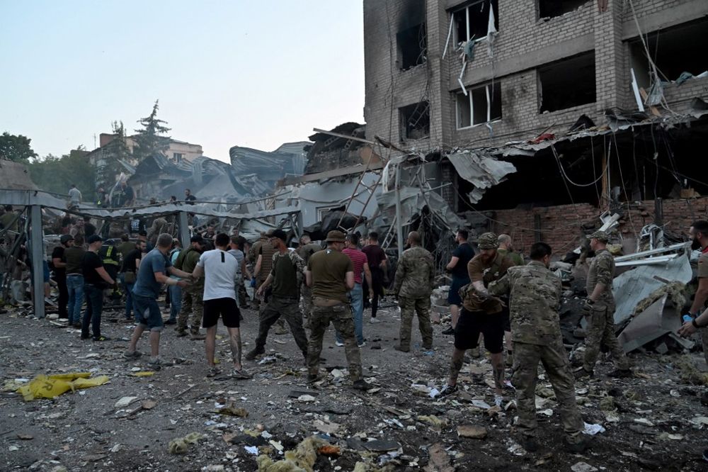 Rescuers and volunteers work to rescue people from under the rubble after a Russian missile strike hit a restaurant and several houses in Kramatorsk, eastern Ukraine.