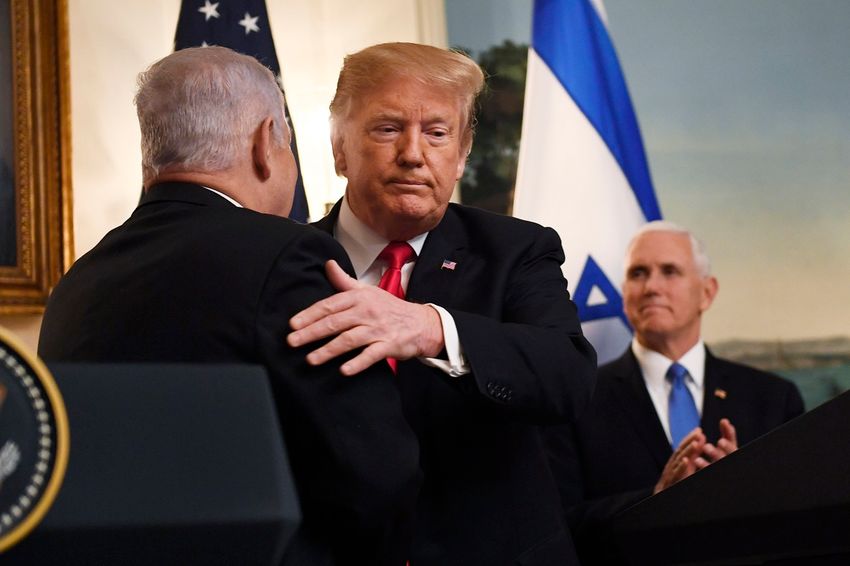 FILE - In this March 25, 2019, file photo, President Donald Trump embraces Israeli Prime Minister Benjamin Netanyahu, as Vice President Mike Pence looks on, in the Diplomatic Reception Room of the White House in Washington
