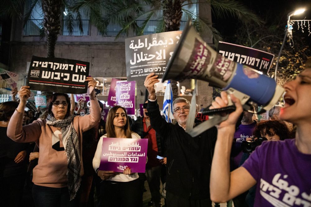 Left wing activists protest against the riots in Hawara, in Haifa, northern Israel.
