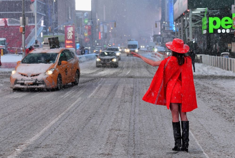 A woman stands in the snow at Times Square in New York City during a heavy winter storm on February 1, 2021.