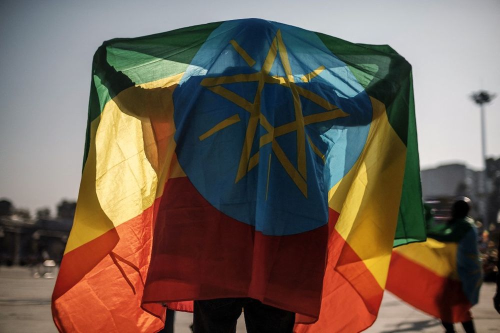 A man covers himself with an Ethiopian flag during a rally in Addis Ababa, Ethiopia, on November 7, 2021.