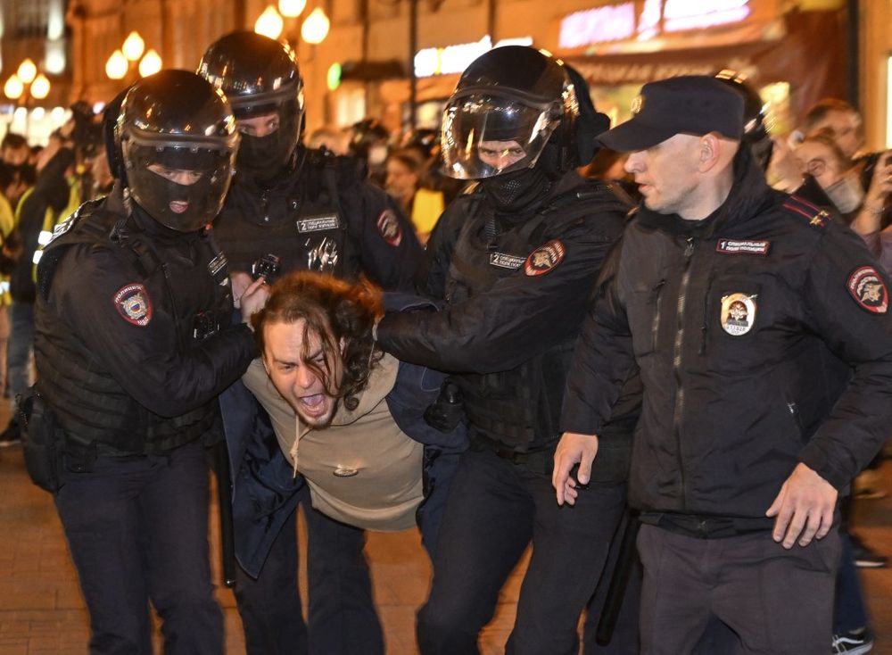 Police officers detain a man in Moscow, Russia, on September 21, 2022, following calls to protest against partial mobilization announced by President Vladimir Putin.