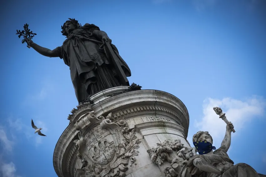 A picture shows a statue (R) symbolising the liberty (and referring to the national motto of France - Liberty, Equality, Fraternity) with its face covered by a European flag Place de la Republique in Paris on February 3, 2019.