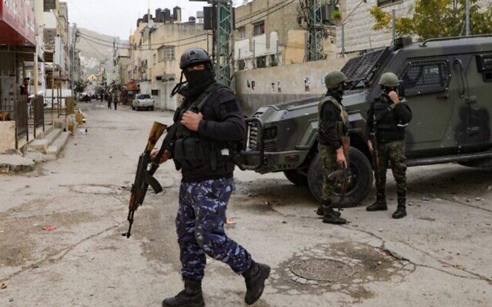 Des forces de sécurité de l'Autorité palestinienne cagoulées se tiennent près d'un véhicule blindé à l'entrée du camp de Balata, près de la ville de Naplouse, en Cisjordanie, le 15 décembre 2020.