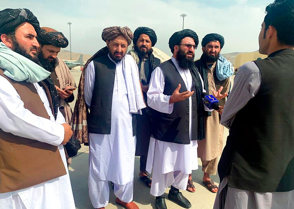 Taliban officials are interviewed by journalists inside the Hamid Karzai International Airport after the US withdrawal in Kabul, Afghanistan, August 31, 2021.