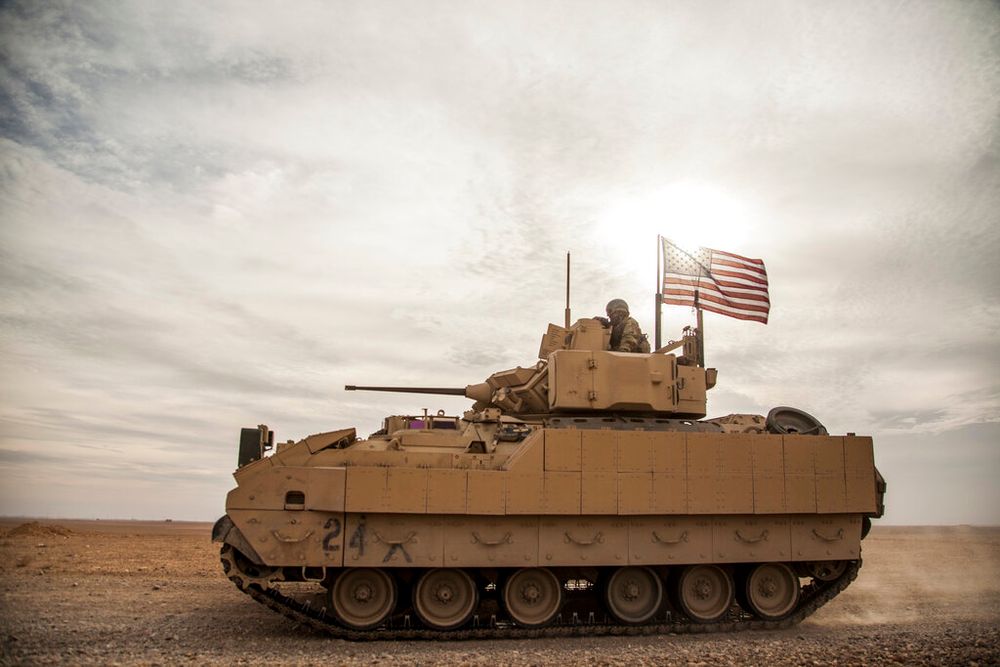U.S. soldiers drive an infantry fighting vehicle in northeastern Syria.