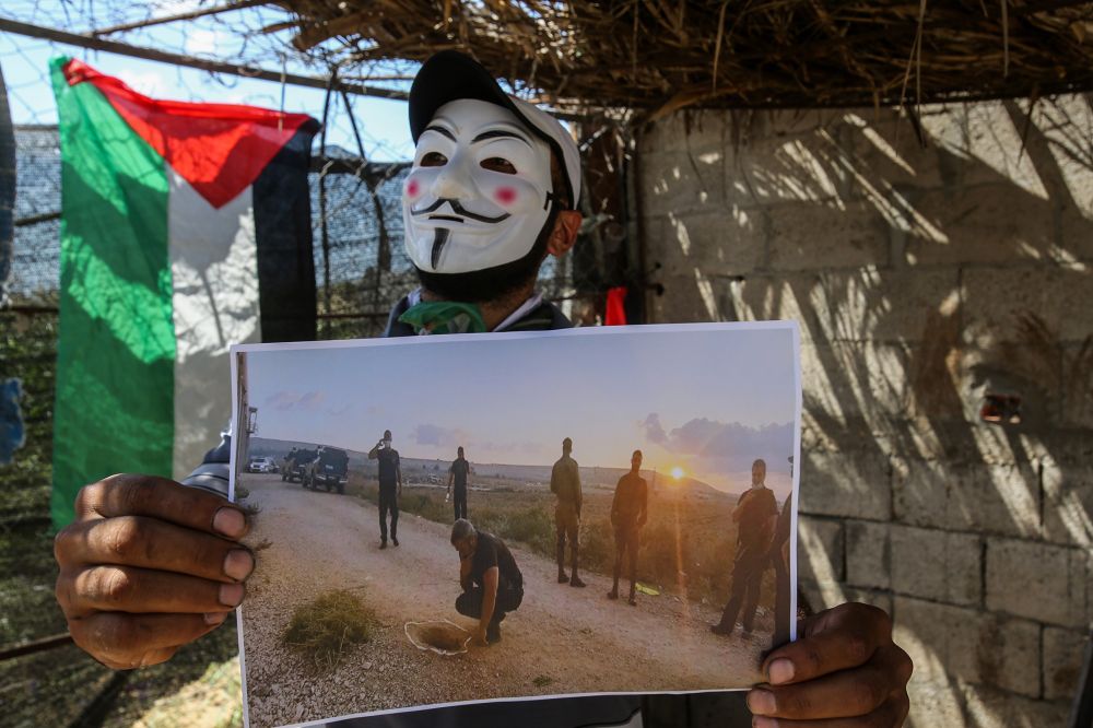 Masked Palestinians launch incendiary balloons towards Israel from the east of the town of Beit Hanoun in the northern Gaza Strip, on September 6, 2021.