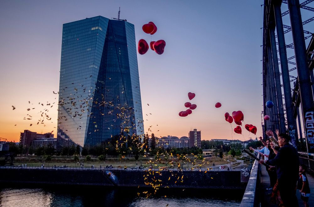 People let balloons fly from a bridge near the European Central Bank in Frankfurt, Germany.