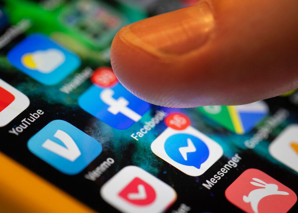 AP Photo/Jenny Kane, File An iPhone displays the apps for Facebook and Messenger.