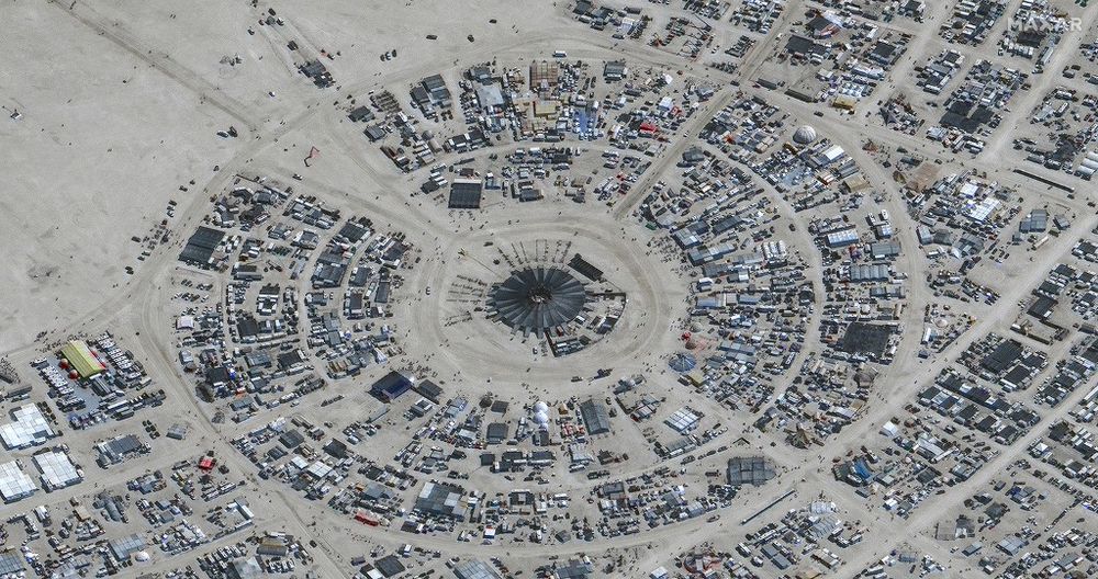 This handout satellite image courtesy of Maxar Technology shows an overview of the annual Burning Man festival underway in Nevada’s Black Rock desert.