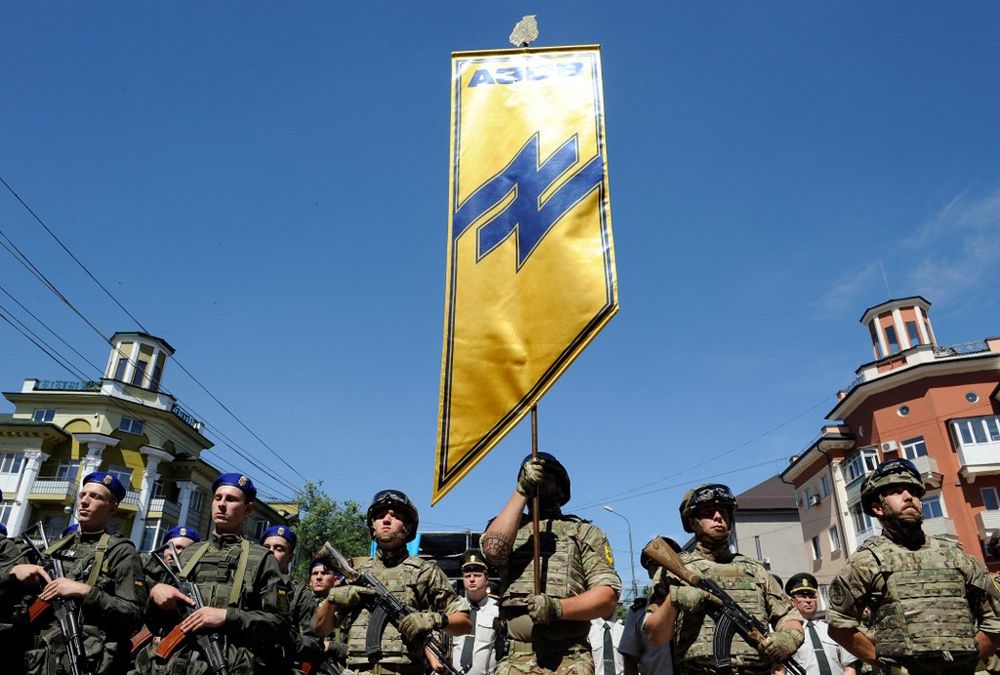 In this file photograph taken on June 15, 2019, servicemen of the Azov regiment and Ukrainian National Guard march through the city of Mariupol, Ukraine.