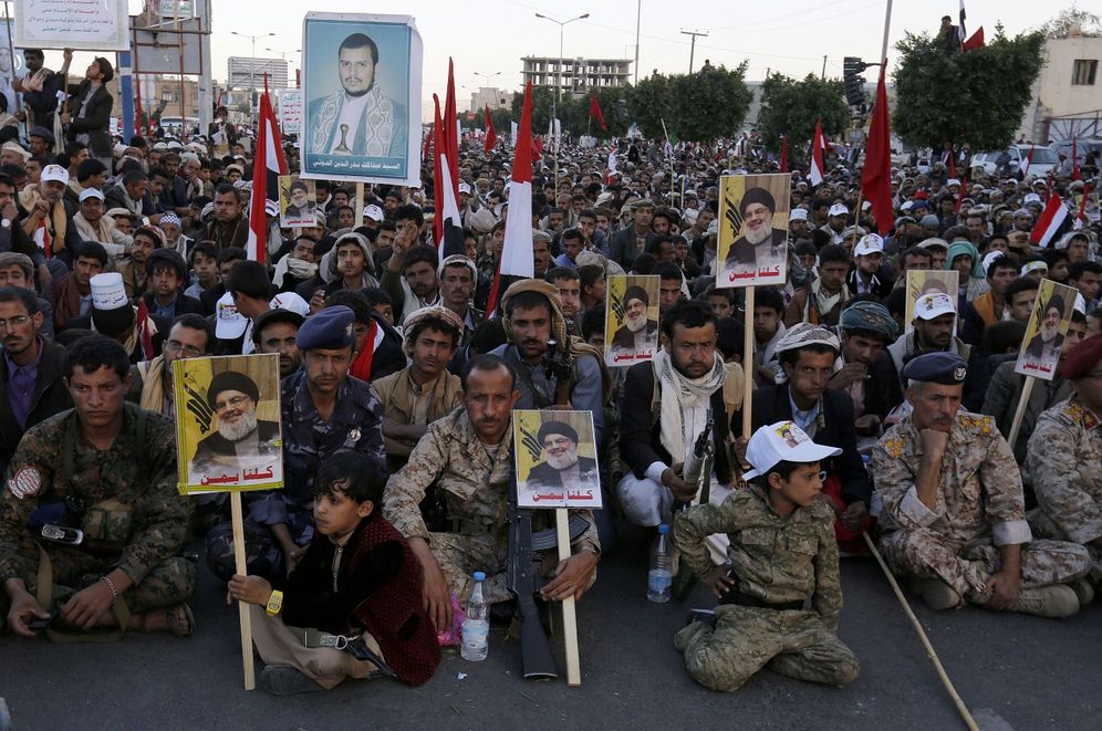 FILE - Shiite rebels, known as Houthis, hold a poster of their leader Abdul-Malik al-Houthi, left top, and posters of Hezbollah leader Sheikh Hassan Nasrallah as they mark the holy day of Ashoura, in Sanaa, Yemen, Wednesday, Oct. 12, 2016