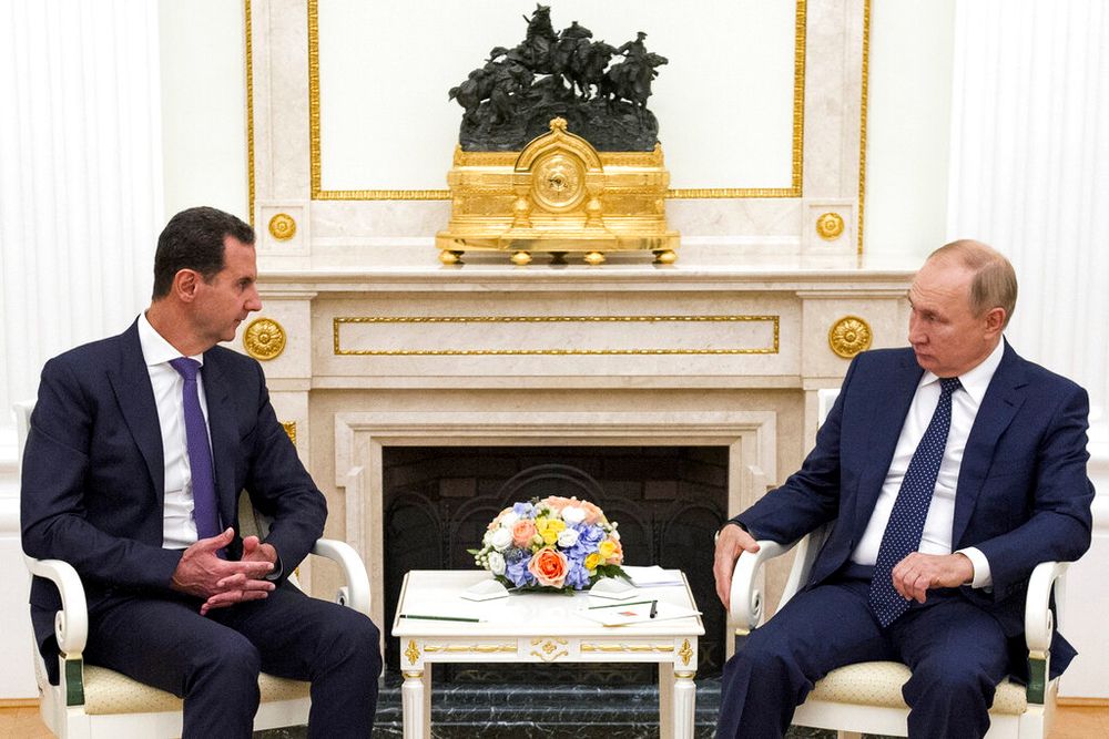 Russian President Vladimir Putin, right, listens to Syrian President Bashar Assad during their meeting in the Kremlin in Moscow, Russia.