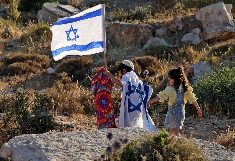 Israeli children walk in the West Bank on the outskirts of Hebron.