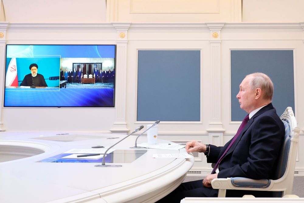 Russian President Vladimir Putin (R) takes part in the signing of an agreement on the construction of the Rasht-Astara railway with Iranian President Ebrahim Raisi via video link in Moscow, Russia.