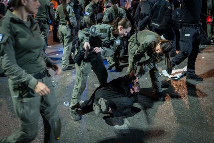 Ultra-Orthodox Jewish men block a road and clash with police during a protest against the jailing of yeshiva students who failed to comply with an army recruitment order, outside the ultra-Orthodox city of Bnei Brak, October 29, 2026.