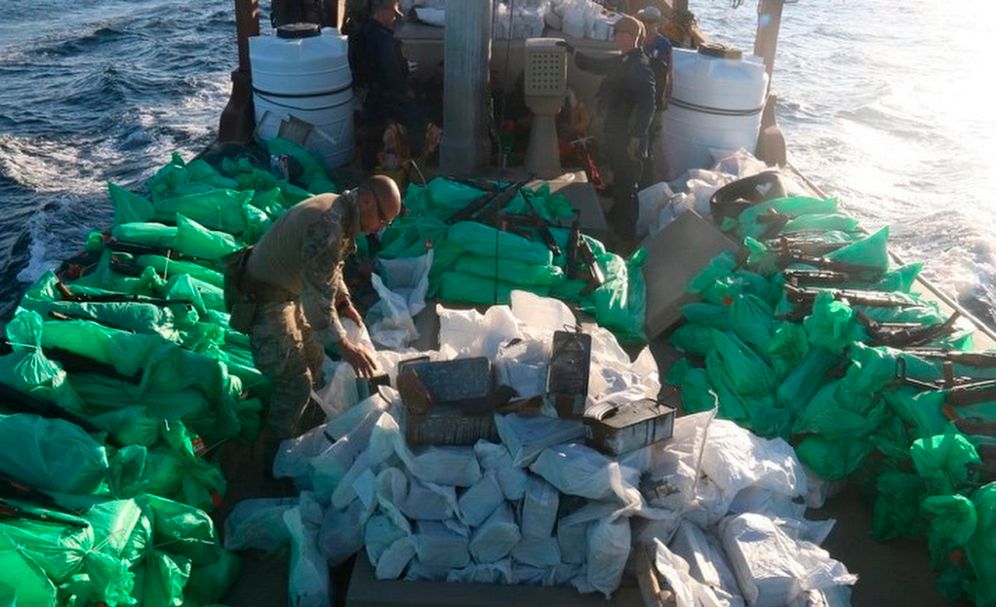 Service members from patrol coastal ship USS Typhoon, inventory an illicit shipment of weapons while aboard a stateless fishing vessel transiting international waters in the North Arabian Sea, December 20, 2021.