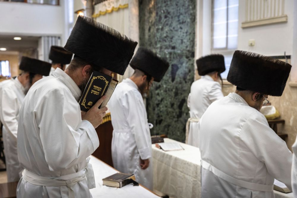 Ultra-Orthodox Jewish men praying in a Jerusalem synagogue.