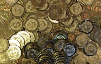 FILE - This April 3, 2013 photo shows bitcoin tokens at software engineer Mike Caldwell's shop in Sandy, Utah. The Federal Reserve Board has denied a Wyoming cryptocurrency bank's application for Federal Reserve System membership, officials announced Friday, Jan. 27, 2023, dealing a setback to the crypto industry's attempts to build acceptance in mainstream U.S. banking. 
