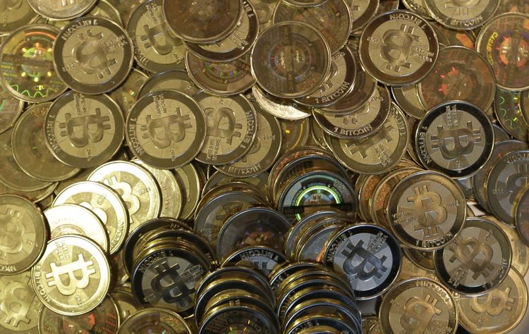 FILE - This April 3, 2013 photo shows bitcoin tokens at software engineer Mike Caldwell's shop in Sandy, Utah. The Federal Reserve Board has denied a Wyoming cryptocurrency bank's application for Federal Reserve System membership, officials announced Friday, Jan. 27, 2023, dealing a setback to the crypto industry's attempts to build acceptance in mainstream U.S. banking. 
