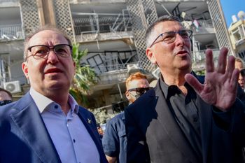 German Interior Minister Alexander Dobrindt and Foreign Affairs Minister Gideon Sa'ar visit the scene where a ballistic missile fired from Iran hit and caused damage in Bat Yam, central Israel, on June 29, 2025

