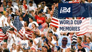 Fans of the United States soccer team, some waving U.S. flags, cheer their team on as they play Switzerland in a World Cup soccer championship Group A, first round match at the Pontiac Silverdome, Michigan, United States, on June 18, 1994.