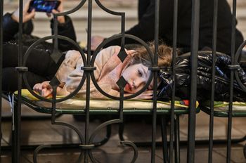 Refugees from Ukraine rest at a temporary shelter in the main train station of Krakow, Poland, on March 6, 2022.