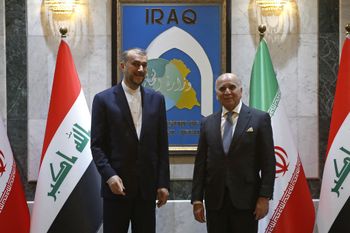 Iraqi Foreign Minister Fuad Hussein (R) receives his Iranian counterpart Hossein Amir-Abdollahian during a visit to Baghdad, Iraq