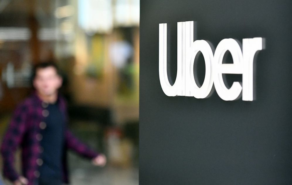 In this file photo taken on May 08, 2019, an Uber logo is seen on a sign outside the company's headquarters in San Francisco, California, United States.