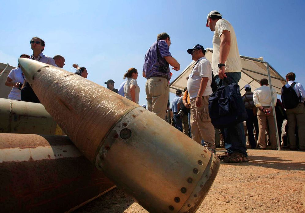 Activists and international delegations stand next to cluster bomb units, during a visit to a Lebanese military base at the opening of the Second Meeting of States Parties to the Convention on Cluster Munitions, in the southern town of Nabatiyeh, Lebanon.