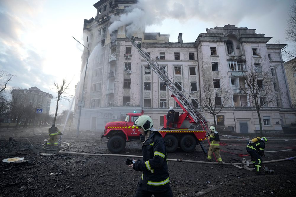 Firefighters work at the site after a Russian attack in Kyiv, Ukraine, Thursday, March 21, 2024.