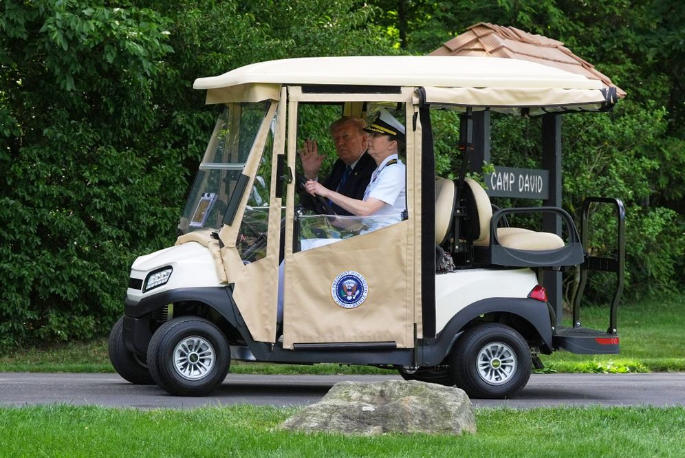President Donald Trump waves as he is driven in a golf cart upon arrival at Camp David, the presidential retreat, near Thurmont, Md., Friday, July 31, 2026. 
