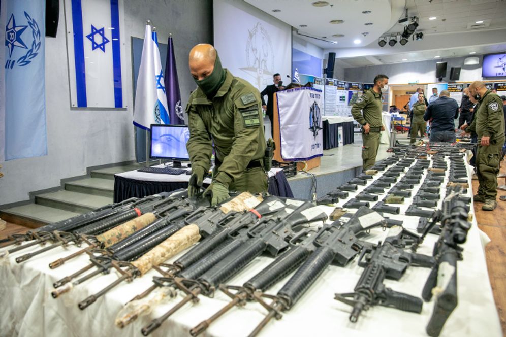 Illegal weapons are displayed during a ceremony after the largest ever police operation against illegal gun dealers in Tel Aviv, Israel, November 9, 2021.