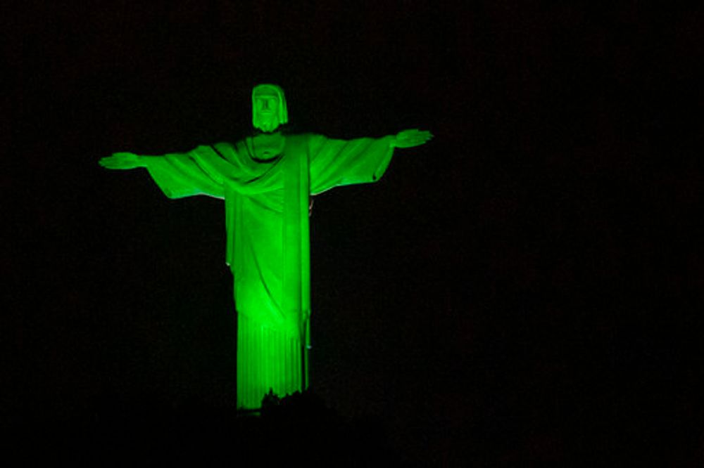 The Christ the Redeemer statue is illuminated in green to mark Amazon Day, in Rio de Janeiro, Brazil, September 5, 2021.