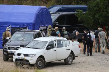 FILE - Police search teams arrive back to an operation tent near Barragem do Arade, Portugal.