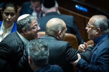 Members of Knesset Itamar Ben Gvir (L) and Ahmad Tibi (R) argue during a vote on the state budget at the assembly hall of the Knesset, the Israeli parliament in Jerusalem