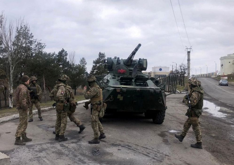 Ukraine's Security Service special forces troops standing past a tank during a large-scale anti-terrorism exercise in Kherson region of the country on April 14, 2021.