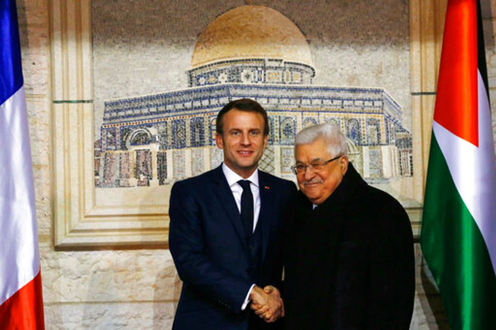 Heidi Levine/Pool photo via AP Palestinian President Mahmoud Abbas, right, welcomes French President Emmanuel Macron at his headquarters in the West Bank city of Ramallah on Wednesday, Jan. 22, 2020.