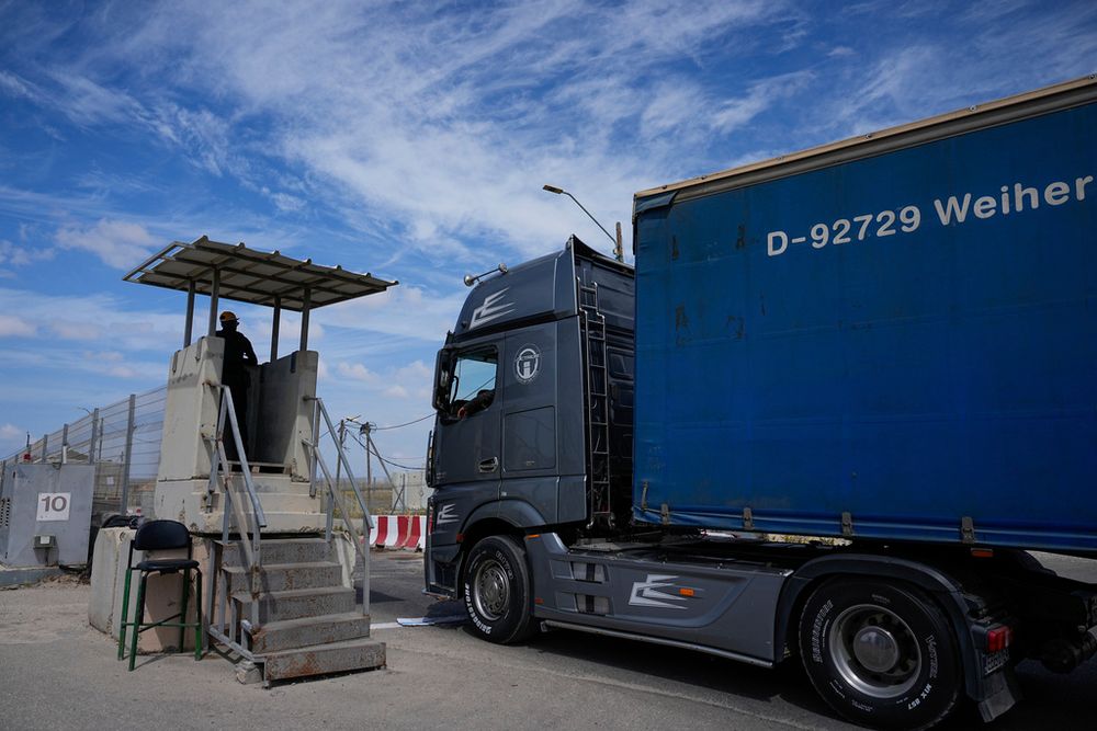 A truck carrying humanitarian aid for the Gaza Strip passes through the Kerem Shalom Crossing in southern Israel, March 14, 2024.