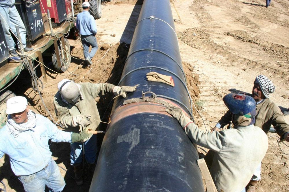 This file photo dated 13 June 2004 shows the Kirkuk-Turkey pipeline, Iraq's main oil export artery being repaired, in Kirkuk, Iraq.