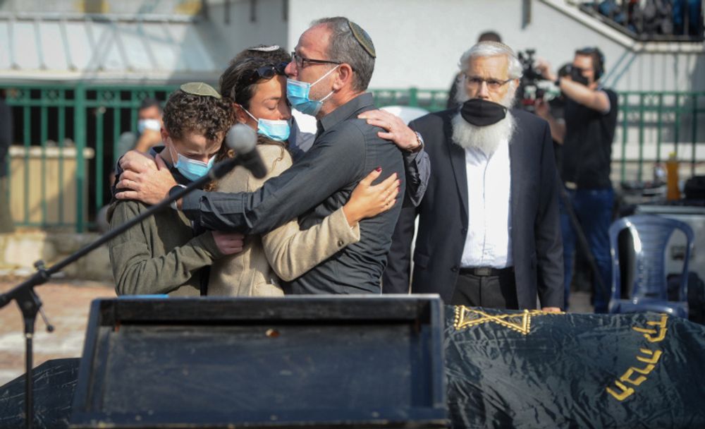 Family and friends attend the funeral of Esther Horgen in Tal Menashe, in the West Bank, on December 22, 2020.