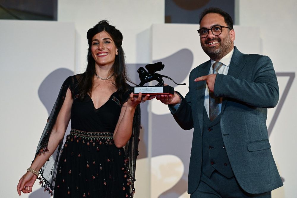 French-Iranian actress Mina Kavani and Iranian actor Reza Heydari pose with the Special Jury Prize at the 79th Venice Film Festival, received on behalf of imprisoned Iranian director Jafar Panahi, for the film 'No Bears' on September 10, 2022.